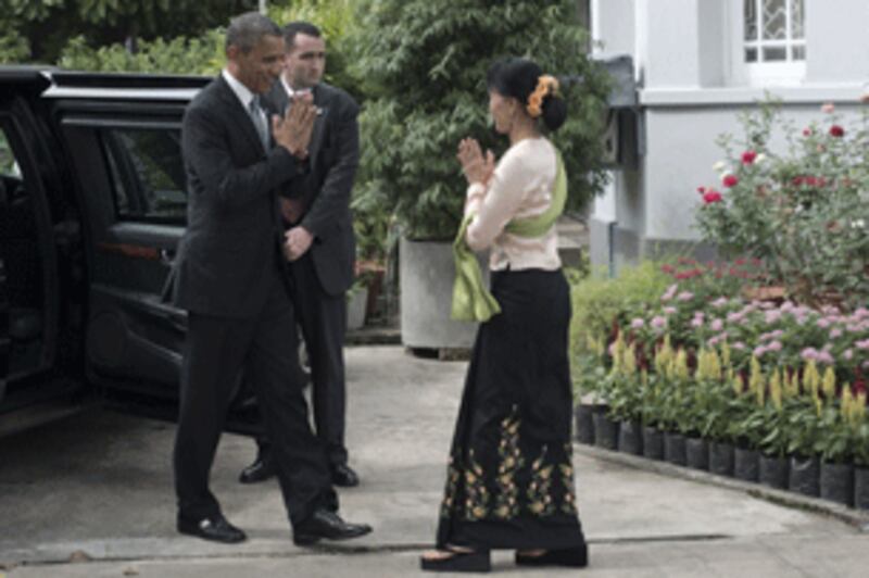 President Barack Obama (L) being greeted by Aung San Suu Kyi (R) at her residence in Rangoon, Nov. 19, 2012.