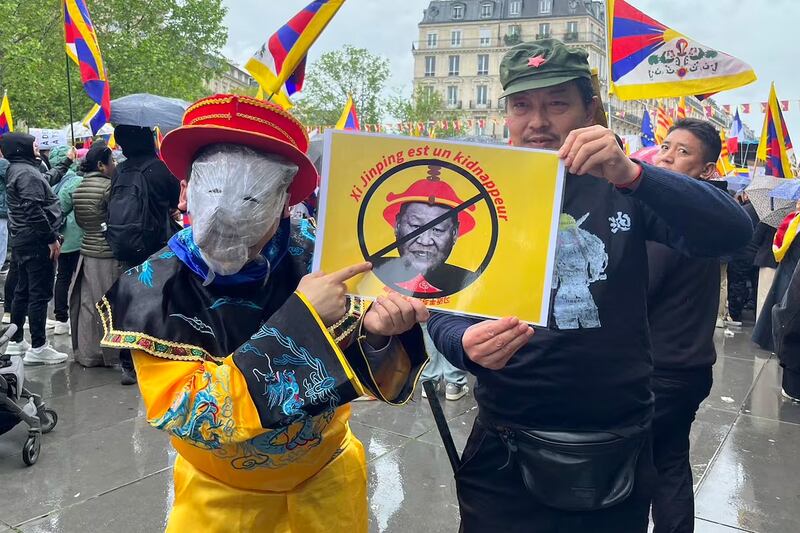 France-based citizen journalist Lin Linqi takes part in a protest against Xi Jinping's visit to France at the Place de la République in Paris, May 5, 2024.