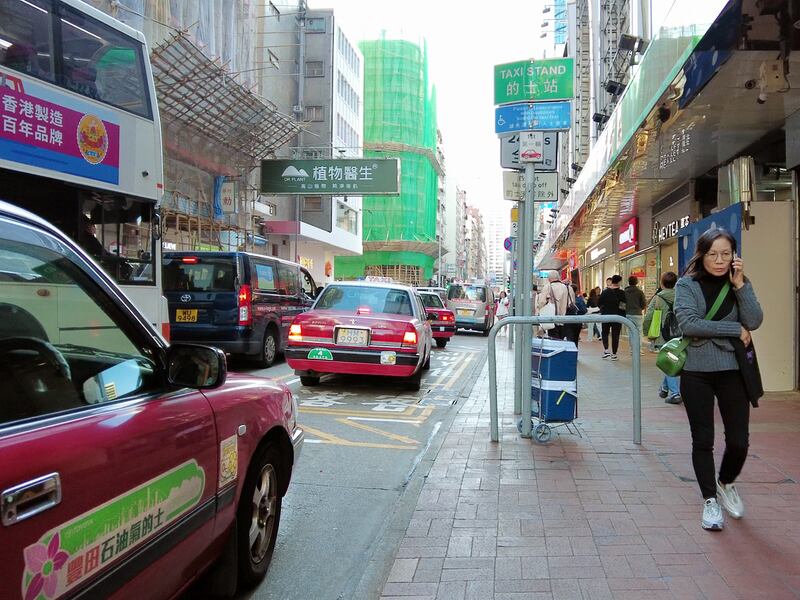 Taxis drive along a street in Hong Kong, Dec. 19, 2024.