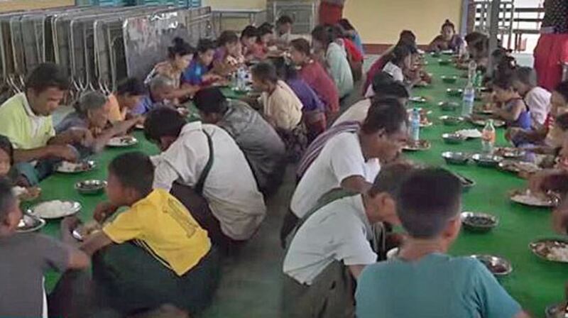 Myanmar civilians displaced by armed conflict eat a meal in a temporary shelter in western Myanmar's Rakhine state, March 19, 2020. 