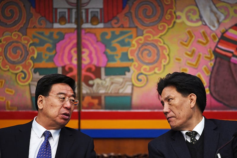 Wu Yingjie, left, Party Secretary of Tibet, talks with Losang Gyaltsen, president of Tibet Autonomous Region People's Congress Standing Committee, during a meeting of the Tibet delegation at the National People's Congress in Beijing, March 6, 2019.