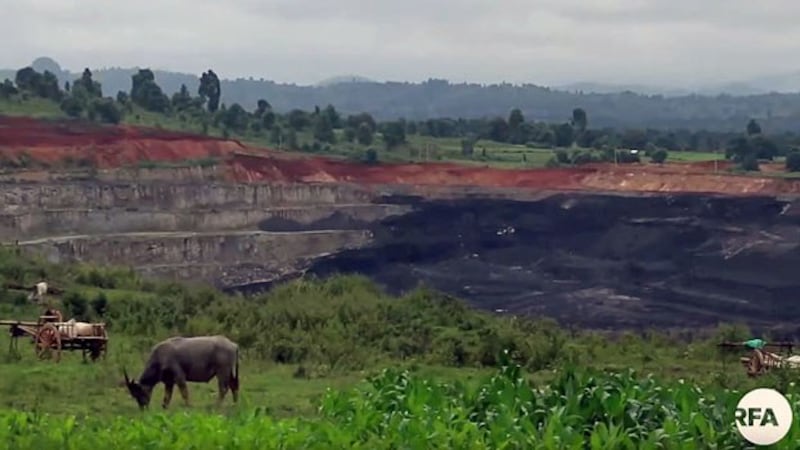 Mountains of coal are piled near a pasture in Tigyit village, Pinlaung township, in Myanmar's northern Shan state, August 2019.