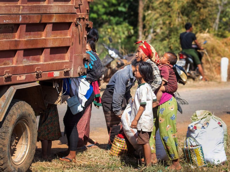 Refugees wait by a truck in Phekhon Township, southern Shan State, Myanmar,  Feb. 18, 2022.