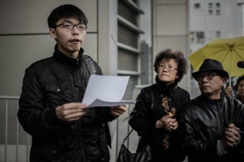 Student activist Joshua Wong speaks outside the Wanchai police station in Hong Kong, Jan. 16, 2015. (Credit: AFP)