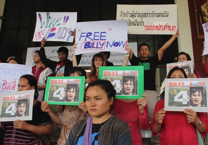 Karen activists hold signs and pictures during a rally calling on Thai authorities to speed up the investigation into their missing colleague, Porlajee Rakchongcharoen outside the governor's office in Chiang Mai, northern Thailand, April 22, 2014. Credit: AP Photo