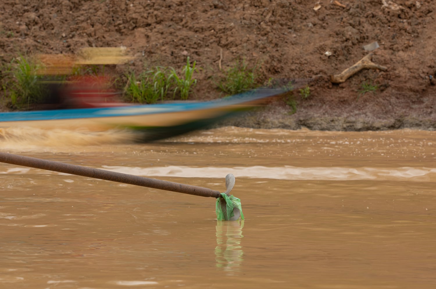 Plastic debris snarls a boat’s propeller as a fishing boat from Kampong Phluk, one of the floating villages on Cambodia’s Tonle Sap Lake, flashes past.