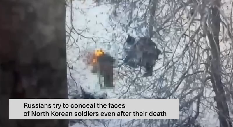 Ukraine President Volodymyr Zelenskyy says this image from a video shows Russians burning the face of a dead North Korean soldier. Part of the image has been blurred by RFA.