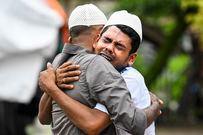 Rohingya refugees embrace each other after taking part in Eid al-Fitr prayers, marking the end of the holy month of Ramadan, at a temporary shelter in Meulaboh, Indonesia's Aceh province, April 10, 2024. (Chaideer Mahyuddin/AFP)