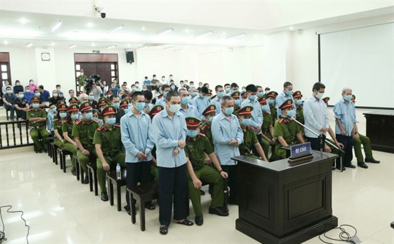 Defendants in Vietnam's Dong Tam trial stand to hear their sentences in a court in Hanoi, Sept. 14, 2020.