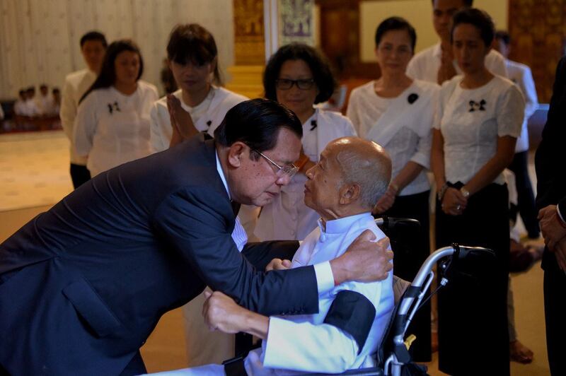 Cambodia's Prime Minister Hun Sen (L) hugs Prince Norodom Ranariddh, during a royal funeral at a pagoda in Phnom Penh, Nov. 20, 2019. Credit: AFP