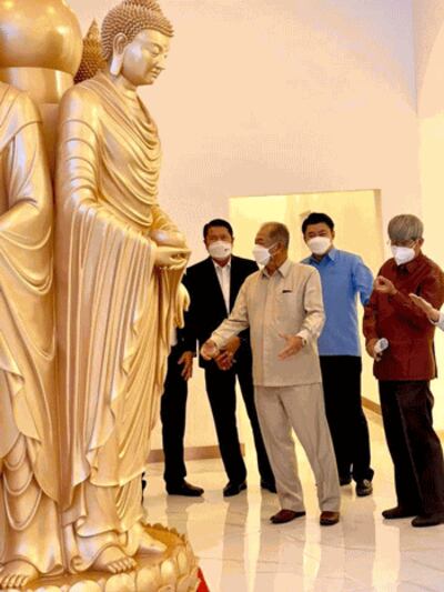 People admire a replica of the Mahayana-style, Chinese Buddha statue that the Wan Feng Shanghai Real Estate Company wants to build in the That Luang Marsh Special Economic Zone in Vientiane, capital of Laos, in an undated photo. Credit: Vientiane's Special Economic Zone Promotion and Management Office