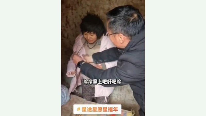 A woman, identified by authorities as Yang Qingxia, but known by her nickname Xiaohuamei, was found chained in a shed in China's Feng county in 2022. Credit: Screenshot from video