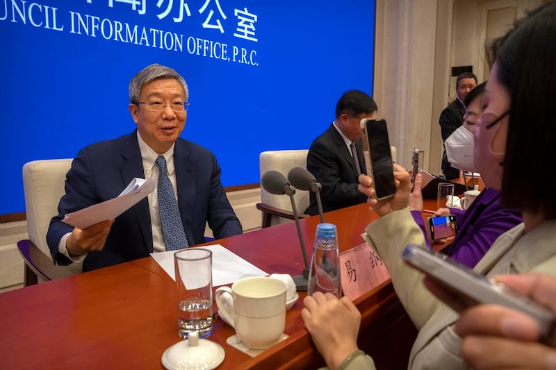 Yi Gang, governor of the People's Bank of China, speaks to journalists after a press conference at the State Council Information Office in Beijing, Friday, March 3, 2023. There are concerns that Chinese President Xi Jinping is moving away from appointing economic technocrats to run the economy. Credit: Associated Press