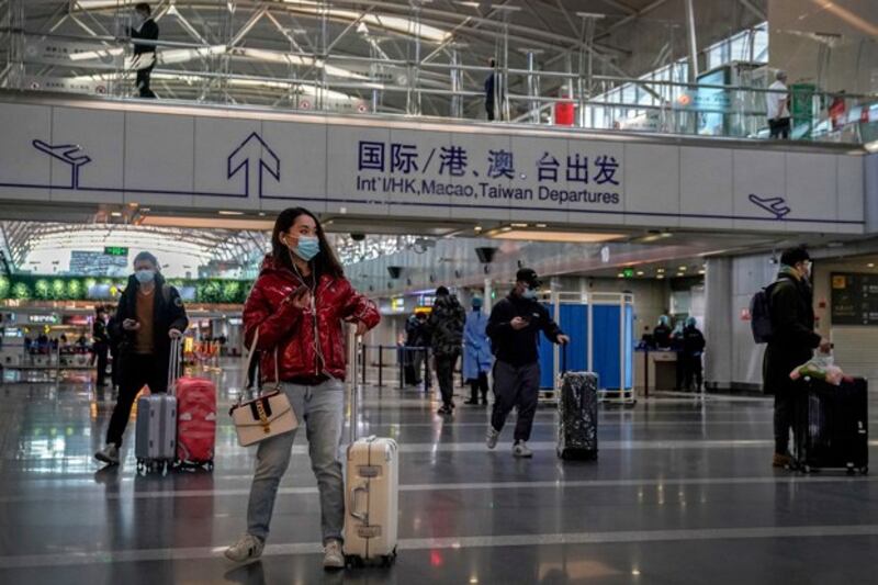 Passengers arrive at the departure hall of the Beijing Capital International Airport to catch their flights, Feb. 3, 2021. (Andy Wong/AP)