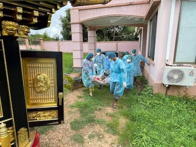 Health workers wearing protective suits carry the body of suspected CVOVID-19 victim in Naypyidaw. Citizen journalist