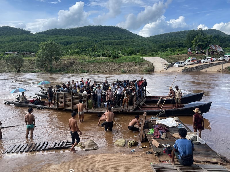 Displaced people from Lashio cross the Dokhtawaddy river as they flee clashes between Myanmar's military and the Ta'ang National Liberation Army, in Myanmar's northern Shan State.