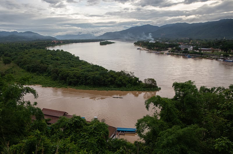 A fishing boat makes its way down the Ruak River into the Golden Triangle region between Myanmar, Laos and Thailand.