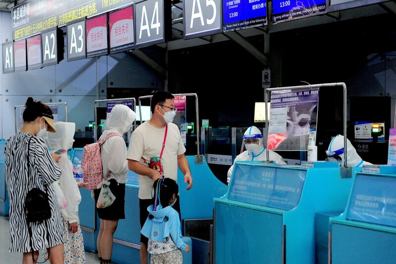 Tourists go through pre-departure procedures at the Sanya Phoenix airport as stranded holidaymakers prepare to leave the COVID-hit resort city of Sanya on Hainan Island, China, on August 9, 2022. Credit: AFP