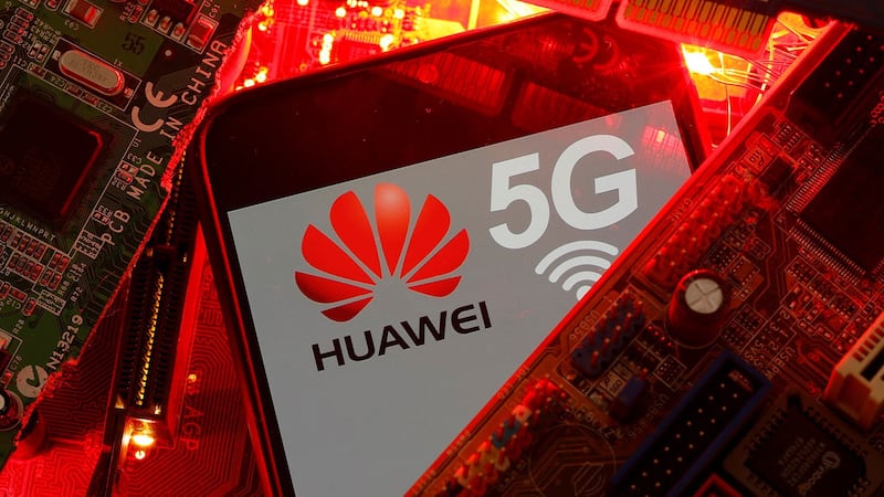 图为在PC主板上可以看到带有华为和5G网络徽标的智能手机。（路透社）