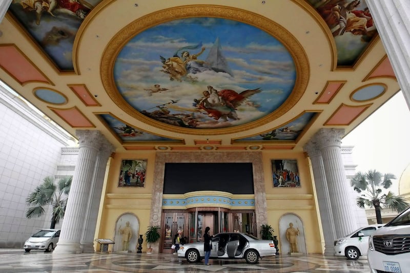 Vehicles stop at the entrance to the Kings Romans casino, part of the Golden Triangle Special Economic Zone in Laos along the Mekong River, Jan. 14, 2012. Credit: Reuters