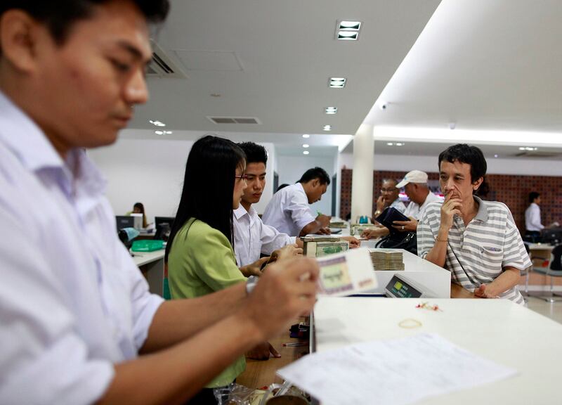 A customer waits to withdraw money at Yoma Bank in Yangon, June 17, 2013. (Soe Zeya Tun/Reuters)