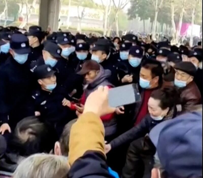 Police scuffle with retirees protesting cuts to medical benefits near the entrance to Zhongshan Park in Wuhan, China, on Feb. 15, 2023. Credit: Screenshot from video obtained by Reuters