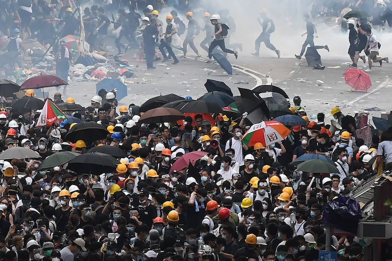 2019年6月12日，香港市民反《逃犯条例》的示威活动中，警察向示威者发射催泪弹。（法新社）