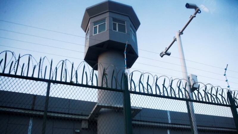 A guard tower rises along the fence of an internment camp in Urumqi's Dabancheng district in Xinjiang in a Sept. 4, 2018 photo. Reuters