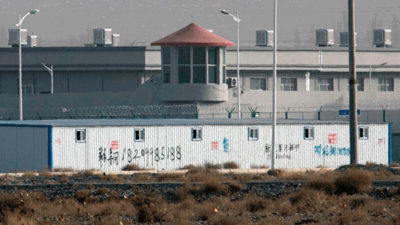 A guard tower and barbed wire fences are seen around a facility at the Kunshan Industrial Park in Artush in northwestern China's Xinjiang region, Dec. 3, 2018. Credit: Associated Press