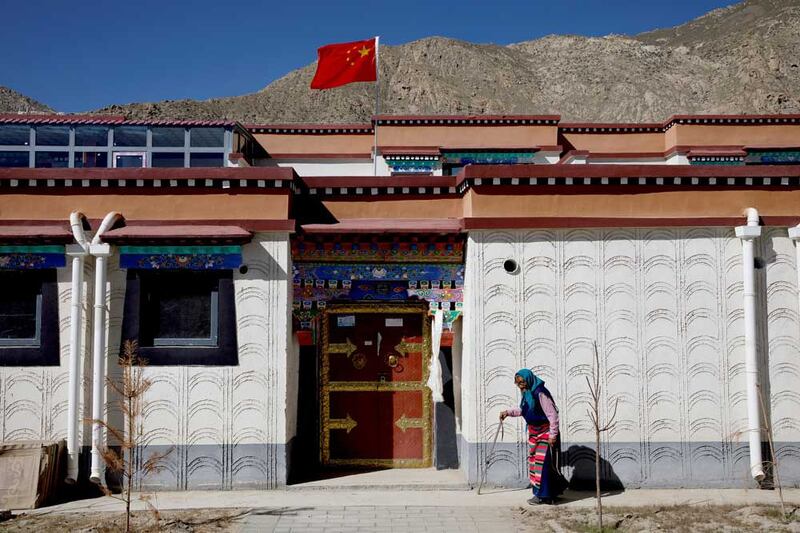 A woman walks in a purpose-built village for Tibetans who have been relocated from high-altitude locations as part of what the authorities call a poverty alleviation program during a government organized tour in Gongga County, Lhoka City, near Lhasa, Tibet Autonomous Region, China, October 14, 2020. (Reuters)