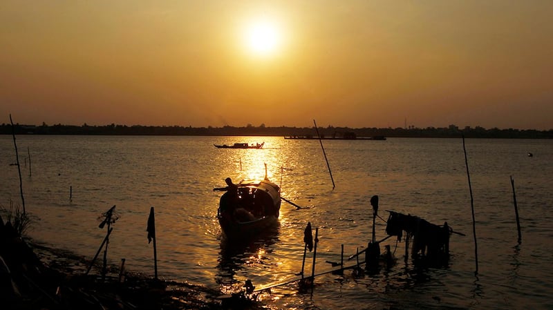 A wooden boat anchored along the Mekong River bank near Phnom Penh, Cambodia, April 24, 2019. Credit: AP Photo