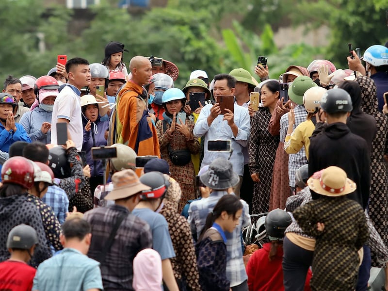 Buddhist monk Thich Minh Tue, center left, stands with local residents in Vietnam's Ha Tinh province on May 17, 2024.