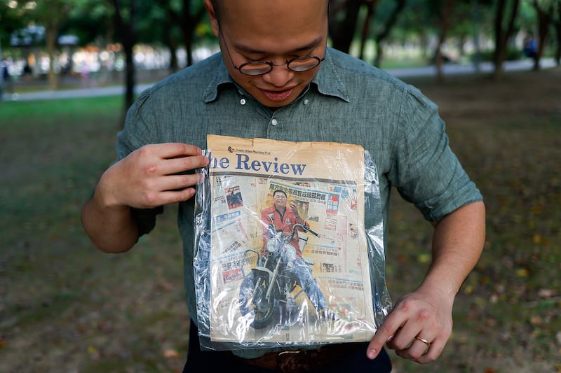 Sebastien Lai, son of Hong Kong media tycoon Jimmy Lai, poses with a newspaper showing a photo of his father in Taipei, Taiwan, Dec.15, 2023.