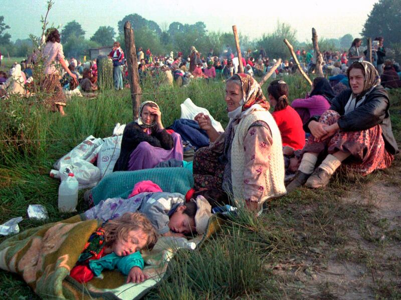 Refugees from the overrun U.N. safe haven enclave of Srebrenica, gather outside the U.N. base at Tuzla airport,  Bosnia and Herzegovina, July 14, 1995.